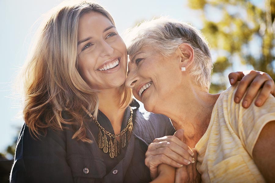 Mother and Daughter laughing with a big smile