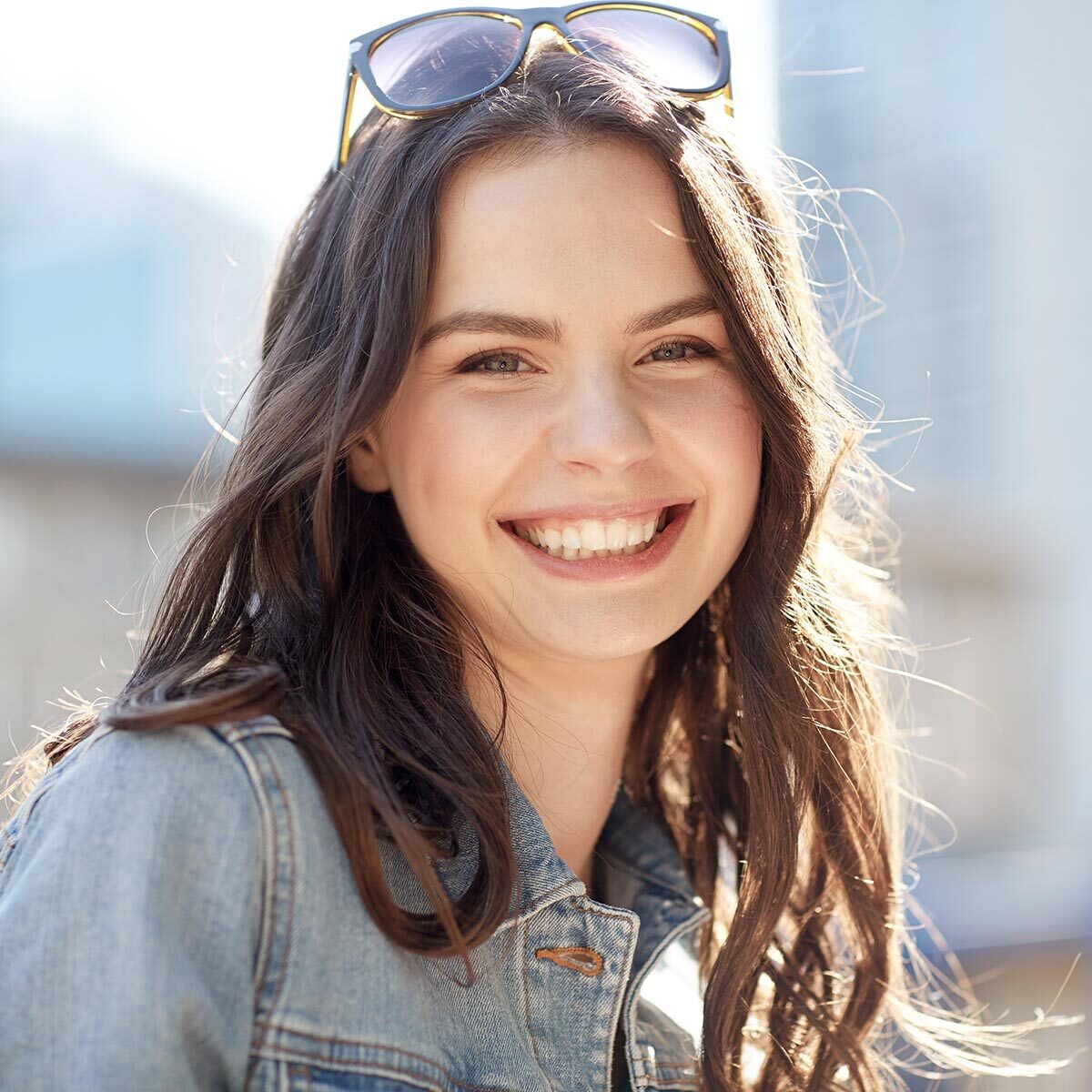 happy smiling young woman on summer city street